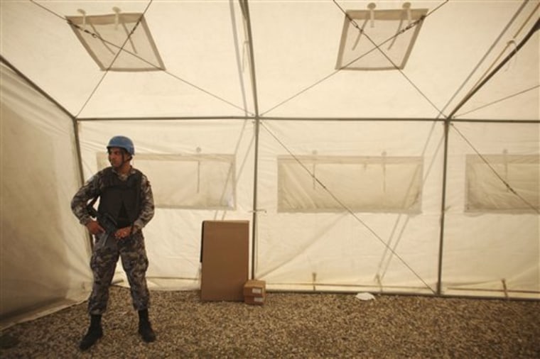 A U.N. peacekeeper from Jordan guards electoral material Saturday at a polling station ahead of the second round of general elections in Port-au-Prince, Haiti, which rch 19, 2011. Haiti will hold runoff elections on Sunday.
